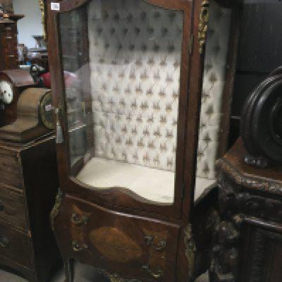 A French style display cabinet with gilt mounts the single door enclosing selfs above two Drawers.