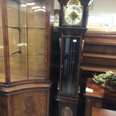 A Continental 20th century Mahogany longcase clock with gilt metal mounts pendulum and three weights.
