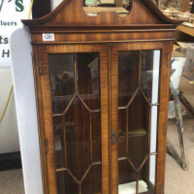 A Mahogany wall cabinet with a shaped pediment the cabinet has three adjustable glass shelf&rsquo;s but no key and a small mahogany corner table. (2)