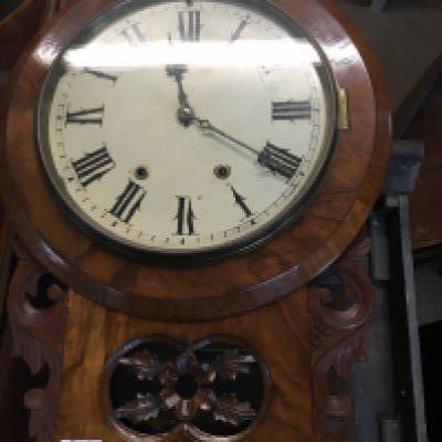 A Victorian walnut wall clock the circular dial with Roman numerals