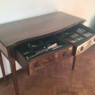 A Mahogany two drawer table with a fitted silver plate canteen of cutlery maker Walker Hall Sheffield.