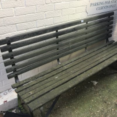 An Early 20th Century wrought iron and wood slat garden bench.
