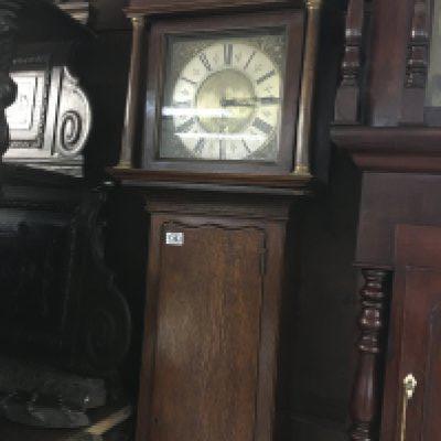 A oak cased 30 hour clock by Oilver Manchester the silver chapter ring with Roman numerals.