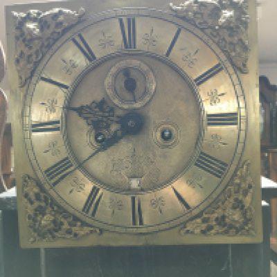 A oak case 30 hour long case clock the brass dial with Roman numerals. No Reserve.