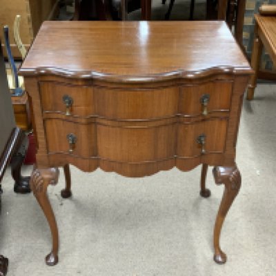 A small 1960s serpentine fronted 2 draw chest. 61cm x 43cm
