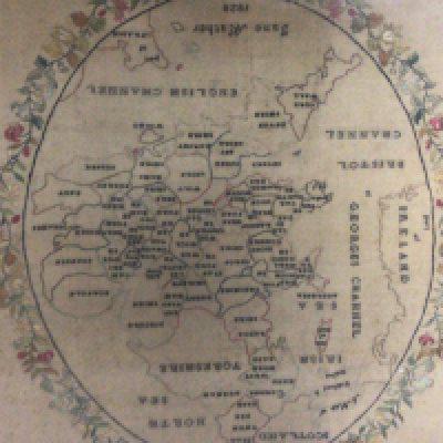 A framed early 19th century needlework sampler a map of the counties of England by Jane Mather 1828. In good condition framed.