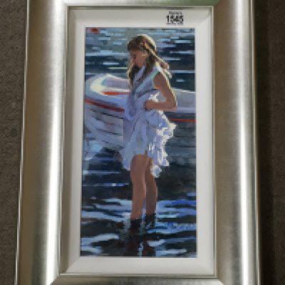 A Limited edition silver Framed print depicting a young girl paddling. By Sheree Valentine Daines