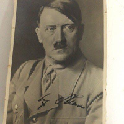 A signed promotional German Third Reich postcard signed in black ink by Adolf Hitler 1889-1945 leader and dictator of Nazi Germany. Ian Kershaw described the life of Hitler as. The embodiment of modern political evil.
