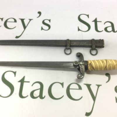 A Third Reich dagger and scabbard. Some damage to handle. Shipping category D.