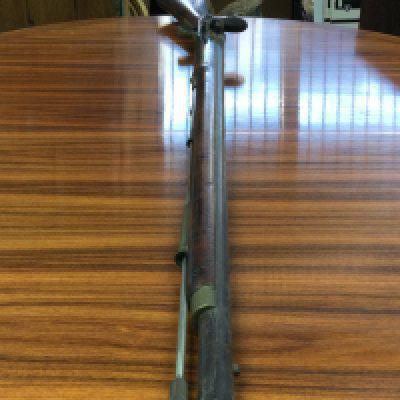 A Flintlock rifle, muzzle load with a walnut stock and proof marks. With a working mechanism. This lot cannot be posted