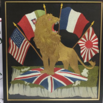 A framed and glazed WW1 embroidery of a lion amongst the flags of the allies entente, approx 46cm x 48cm. Shipping category D.