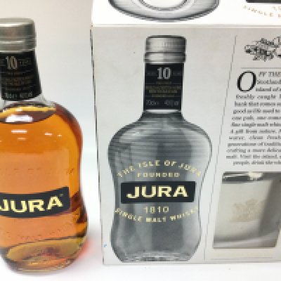 A bottle of Jura 10 years single malt. 700ml sealed and boxed with a hip flask.