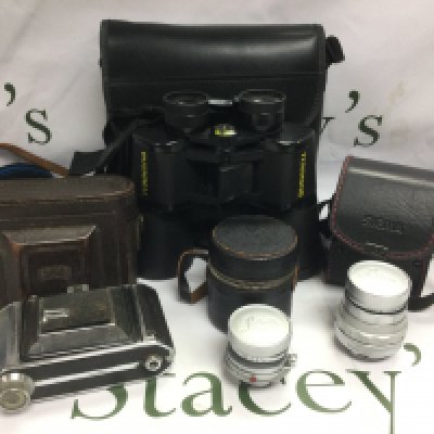 A Zeiss Ikon camera, two Leica lenses and a pair of Bushnell binoculars. Shipping category D.