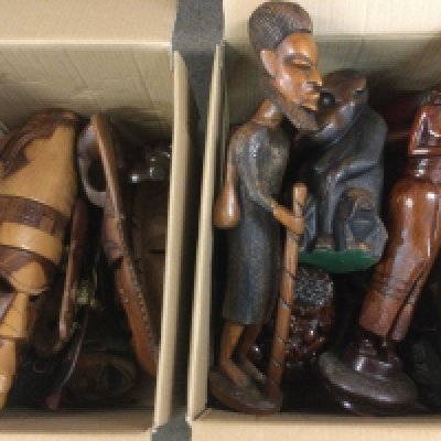 Two boxes of carved wooden tribal masks, figures and other ornaments. Shipping category D.