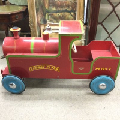 A child&rsquo;s peddle train leeway flyer painted red. 107cm long 46cm wide.