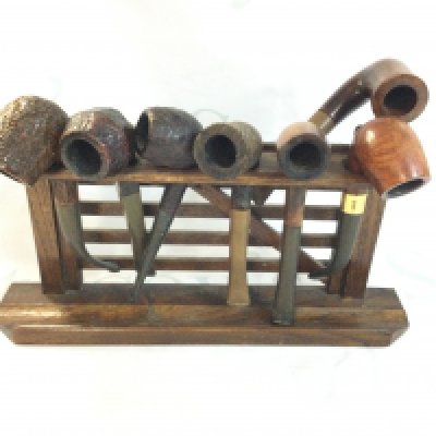 A gate style pipe holder with 7 pipes. Postage B