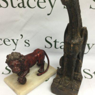 A mixed metal figure of a lion raised on a marble base, approx height 16.5cm and a plaster gargoyle, approx height 37cm. Shipping category D.