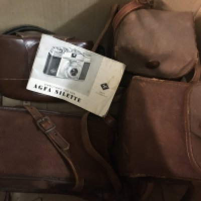 A box containing cameras various including Kodak