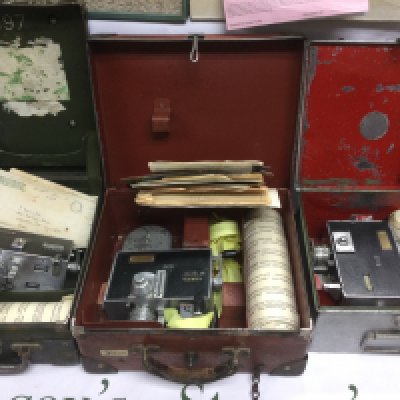 Three vintage bus conductor's ticket machines housed in original carry cases with unused rolls of tickets. Shipping category D.