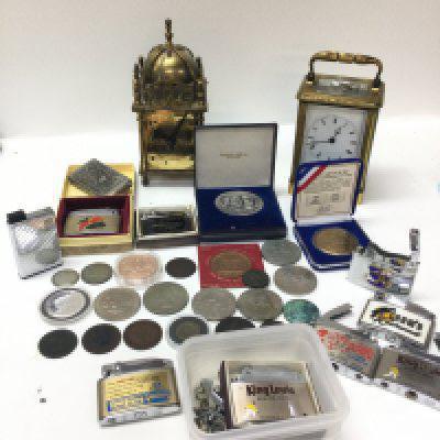 A collection of British coins including a George III penny, Royal Mint 1843 sovereign brass weight , lighters, British Smiths and French Scherer carriage clocks (in need of restoration). This lot cannot be posted