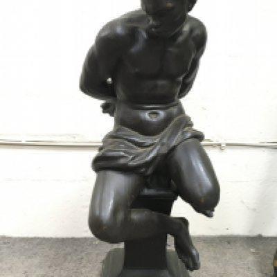 A bronze lamp base figure of a seated man in captivity. 50cm tall approximately. This lot cannot be posted