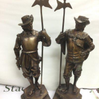 A pair of heavy resin figures of cavaliers holding pikes and raised on hexagonal bases, approx height 66cm. Shipping category D.