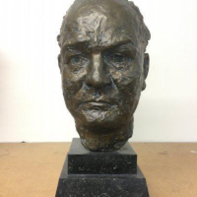 A bronze bust of Sir Winston Churchill raised on a marbled plinth, approx height 42cm. Shipping category D.