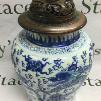 A blue and white lidded vase depicting a dragon chasing a pearl, the hardwood lid having carved piercework decoration, approx total height 41cm. Shipping category D.