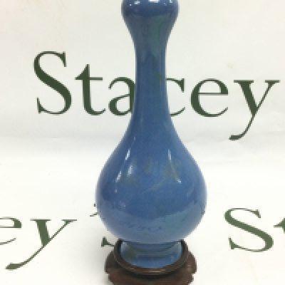 A Chinese garlic vase in blue and raised on a carved hardwood stand, approx total height 20.5cm. Shipping category D.
