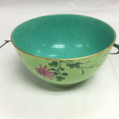 A hand painted Oriental bowl with floral decoration on a green ground with a darker green to the interior, approx diameter 11cm. Shipping category D.