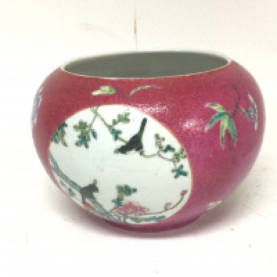 A 19th century Chinese Export Porcelain jardiniere hand painted with oval panels with flowers and foliage on a red patterned ground caricature marks to the base no obvious cracks or chips 25cm diameter.