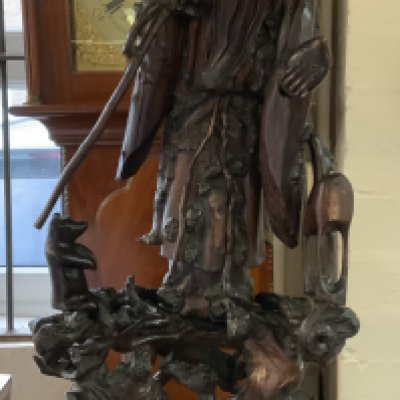 19thc Chinese carving of Shou Lao with a staff and peach on a naturalistically modelled stand. 67.5cm.