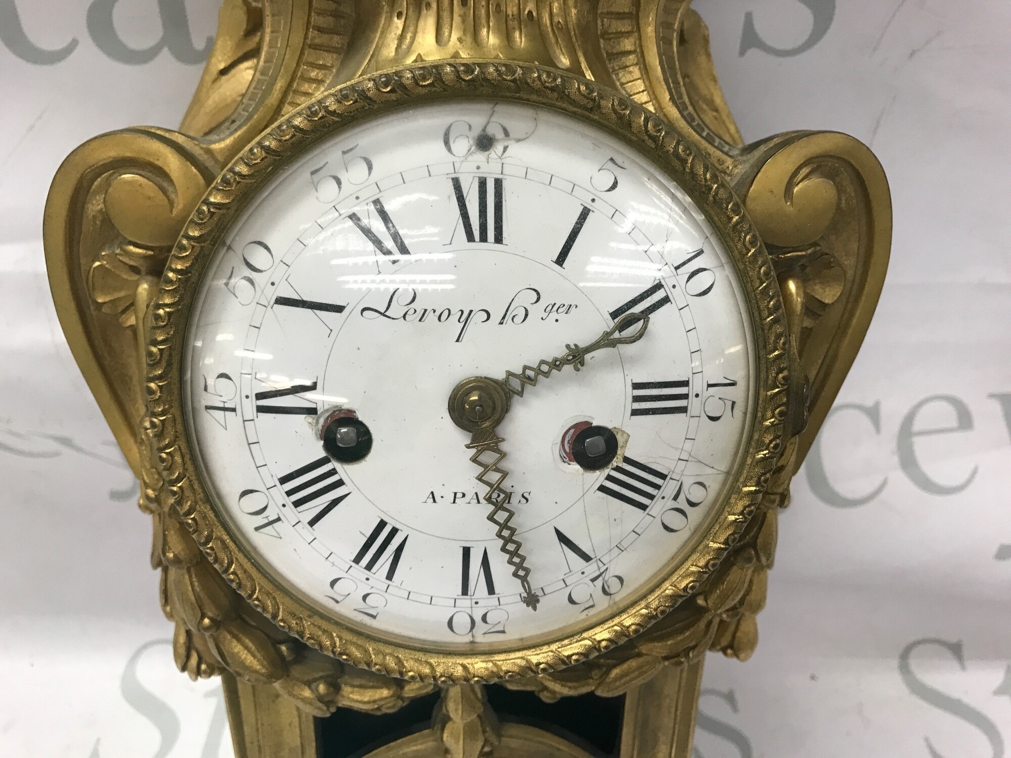 A vintage French gilt wall clock with white enamel face which does have some hairline cracks and chips. Approx 44cm by 23cm