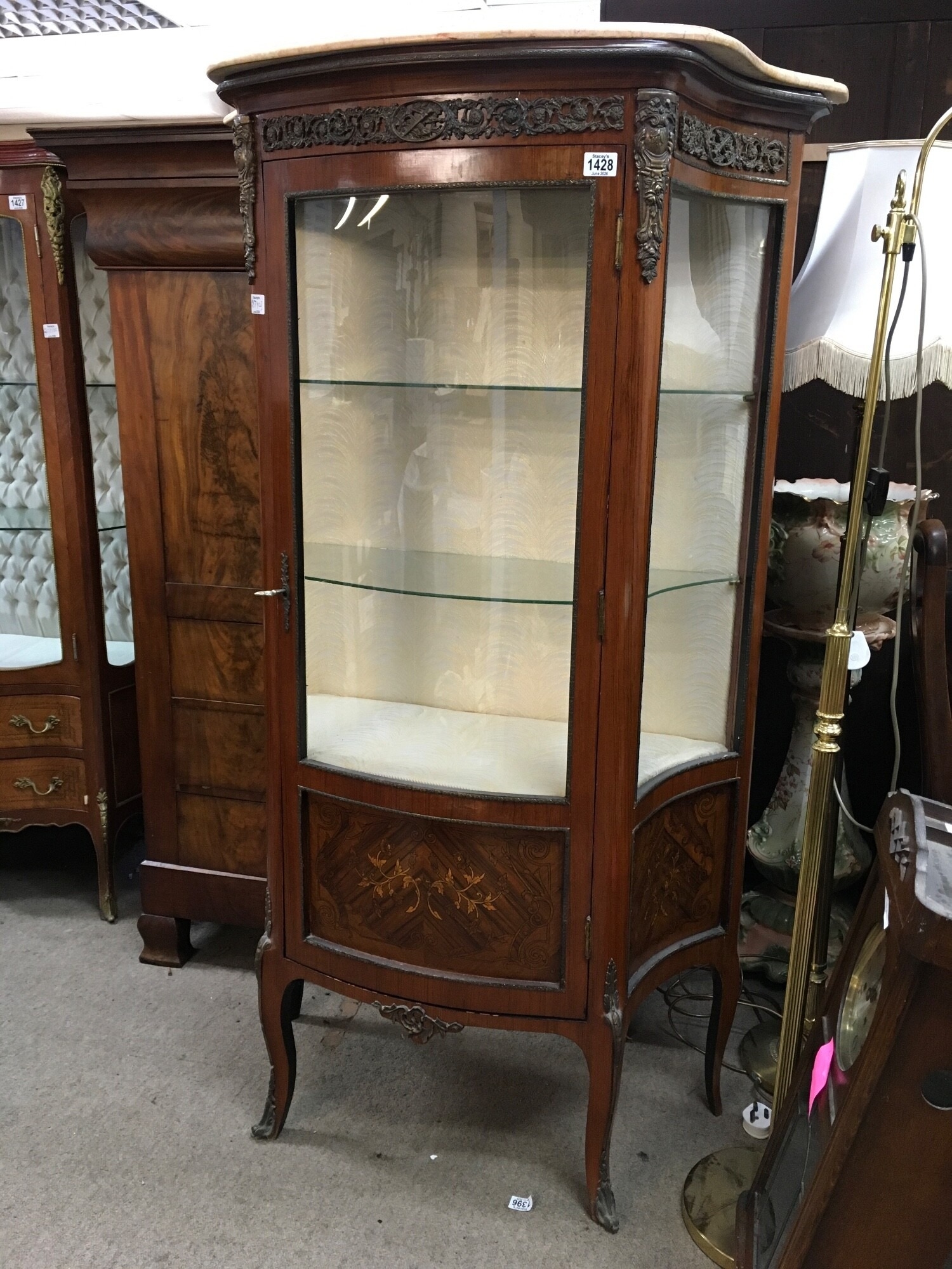 A French Style cabinet having sinkge door, enclosing two glass shelves. With marble top and classical mounts on cabriole legs
