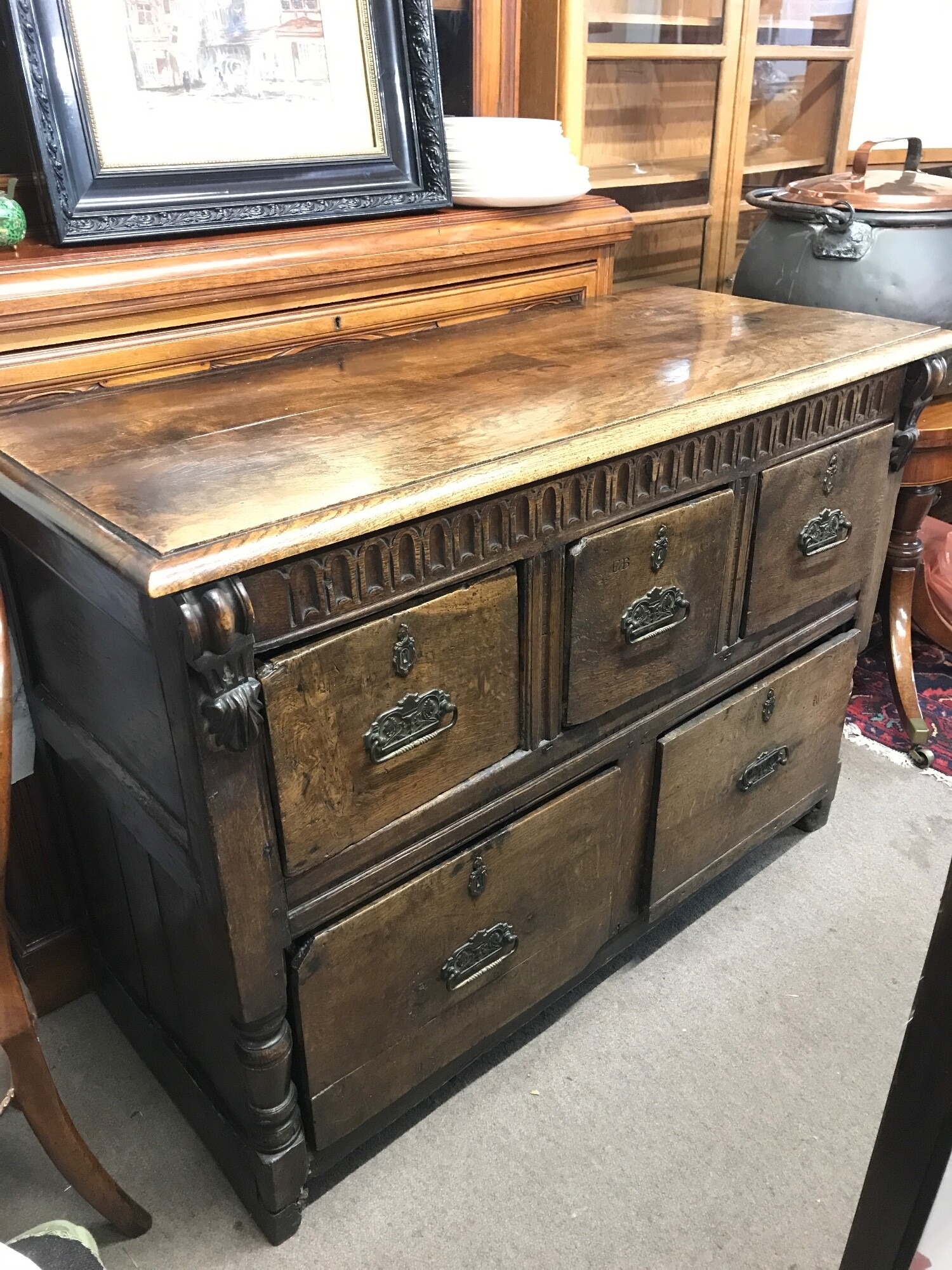 A Vernacular oak chest of drawers possibly 17th century, with later alterations. 126cm wide, 55cm long, 90cm tall