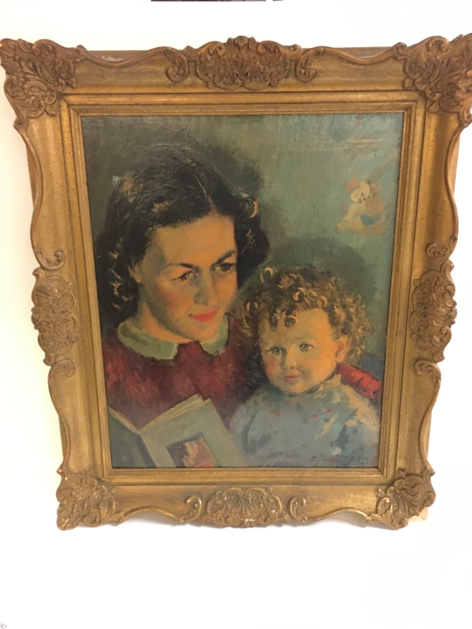 A James Proudfoot (1908-1971) framed oil painting of a mother and child reading a book signed November 1941. Picture size 40x50cm