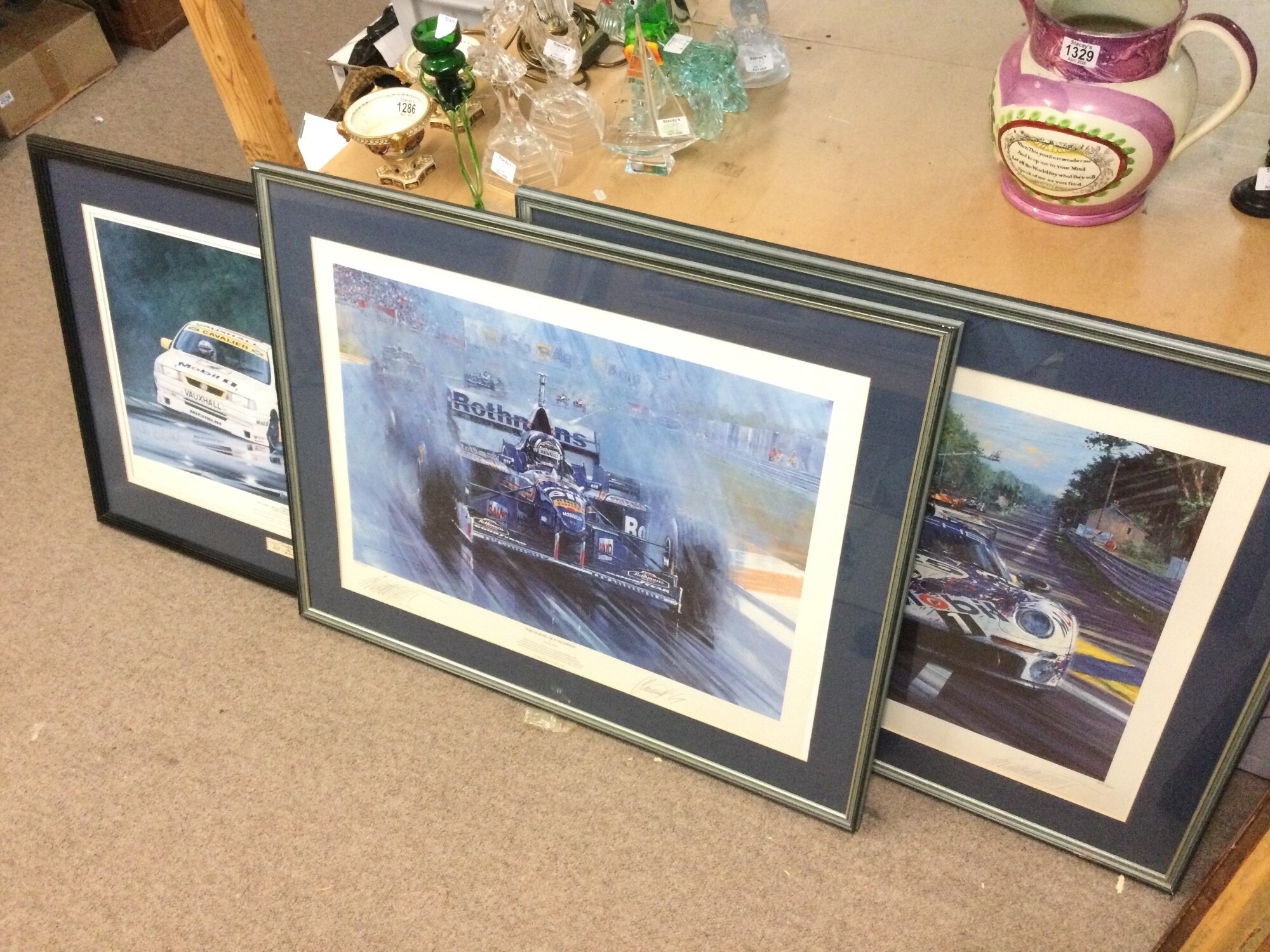 Three formula one and Le Mans signed racing prints. Frame dimensions 88x87cm and 79x63cm NO RESERVE