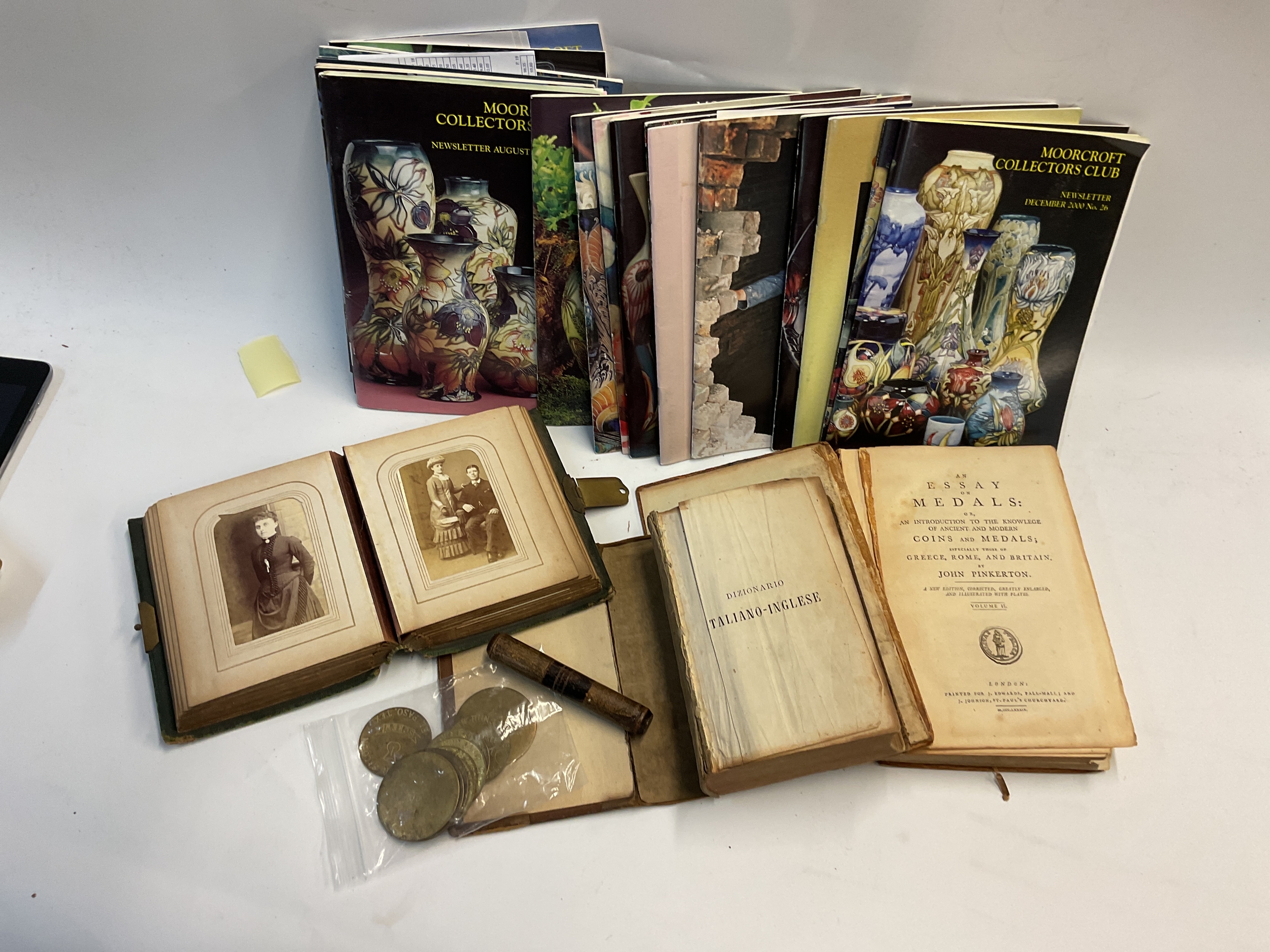 Ephemera to inc vintage coin book, photo album, Moorcroft collectors magazine, Harold MacMillan seating plan, bodkin case and tokens.