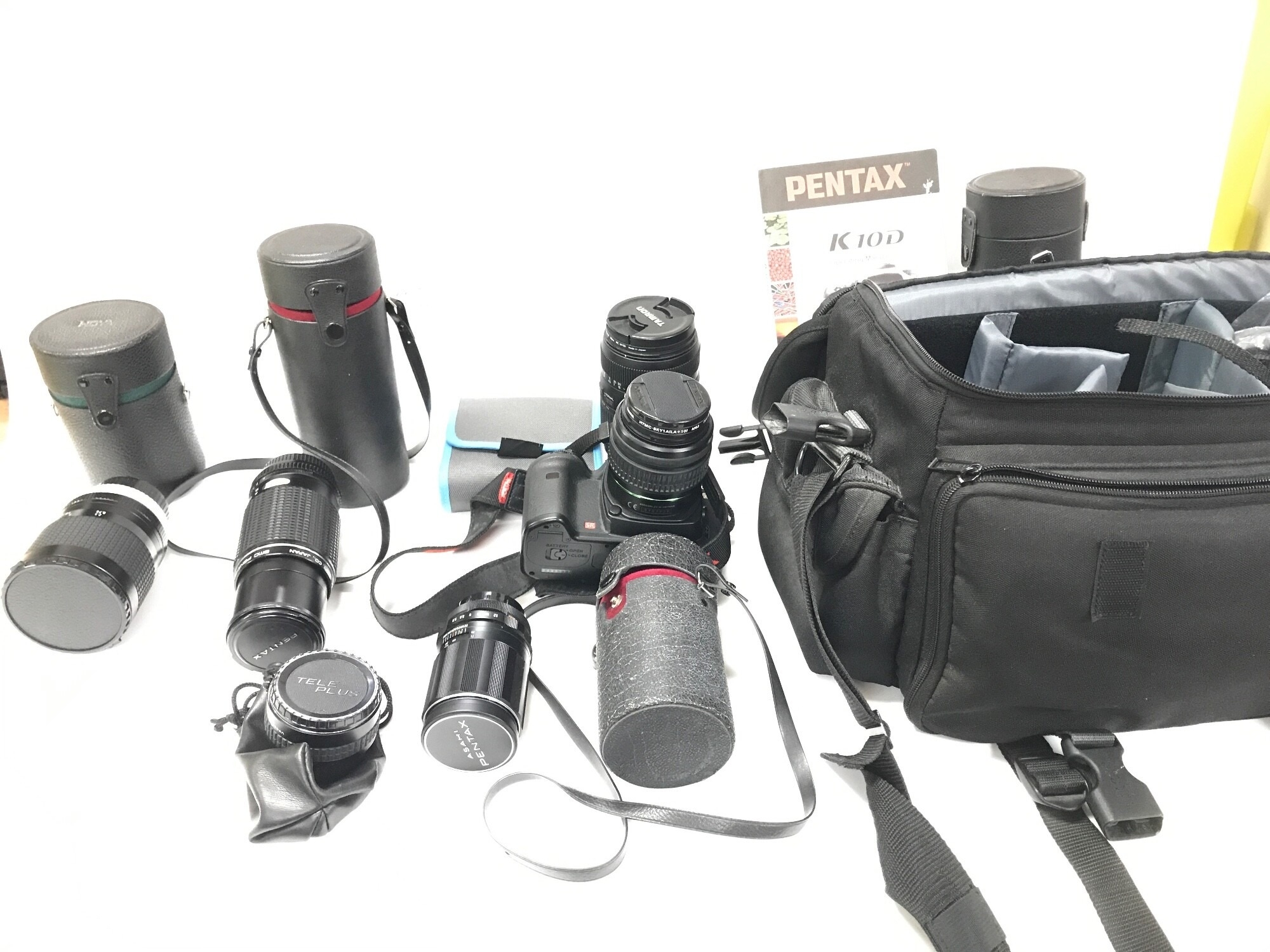 A Pentax SLR camera with additional lenses.
