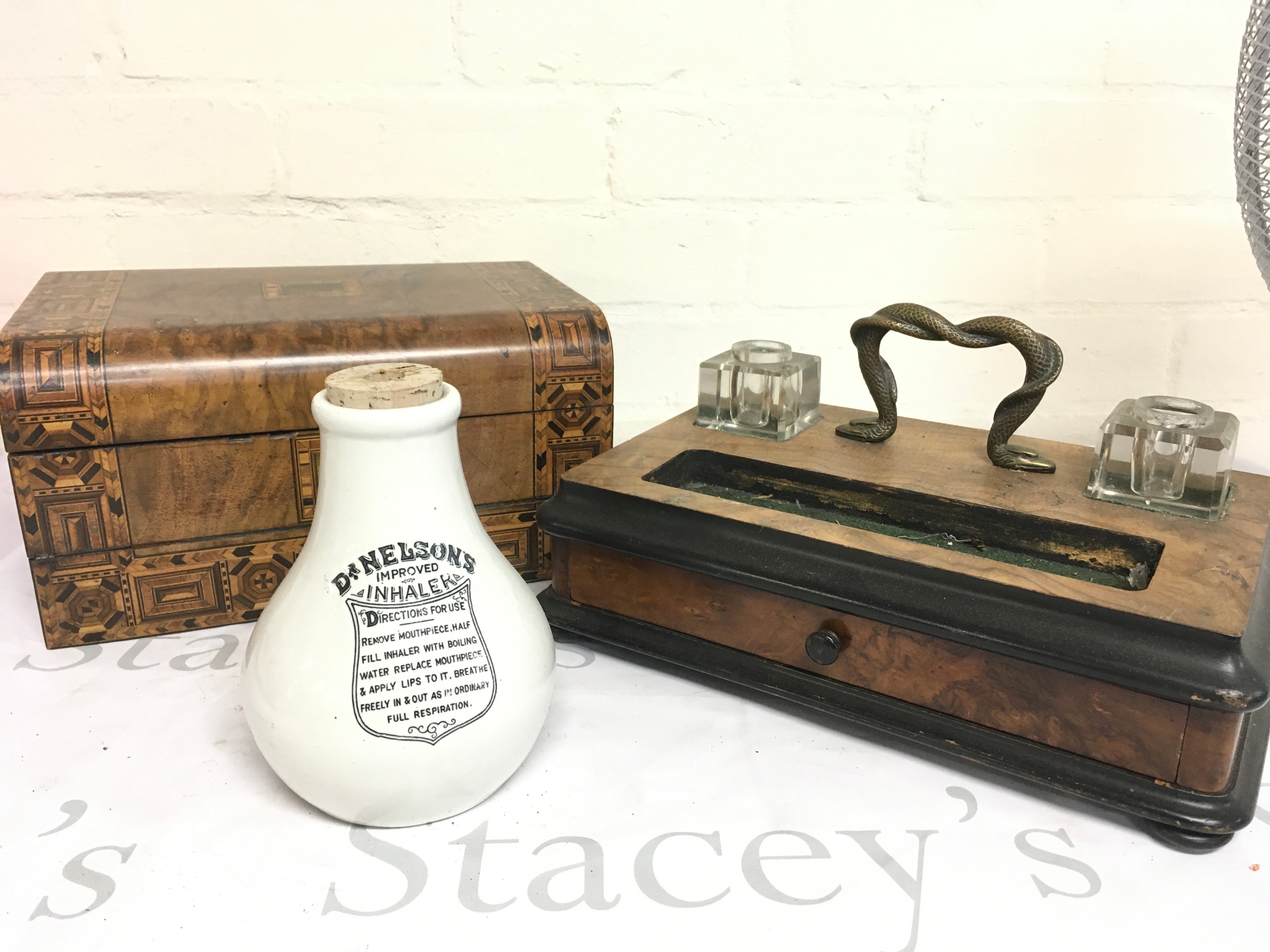 A walnut inkstand features a unique snake-shaped carrying handle, writing slope featuring intricate geometric marquetry and parquetry inlay, Dr Nelsons improved inhaler
