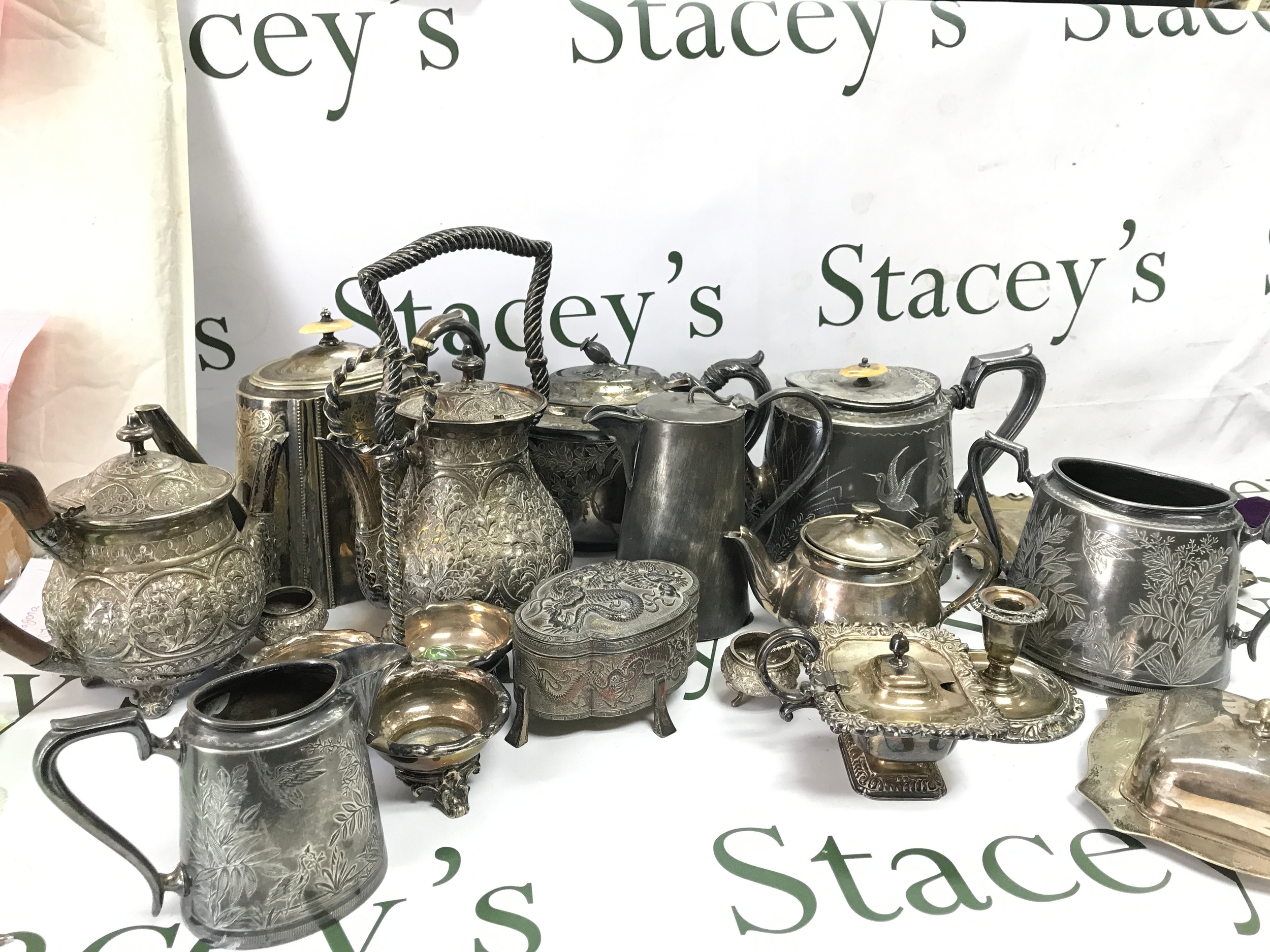 A Collection of silver plate including teapots, jugs, candleholder