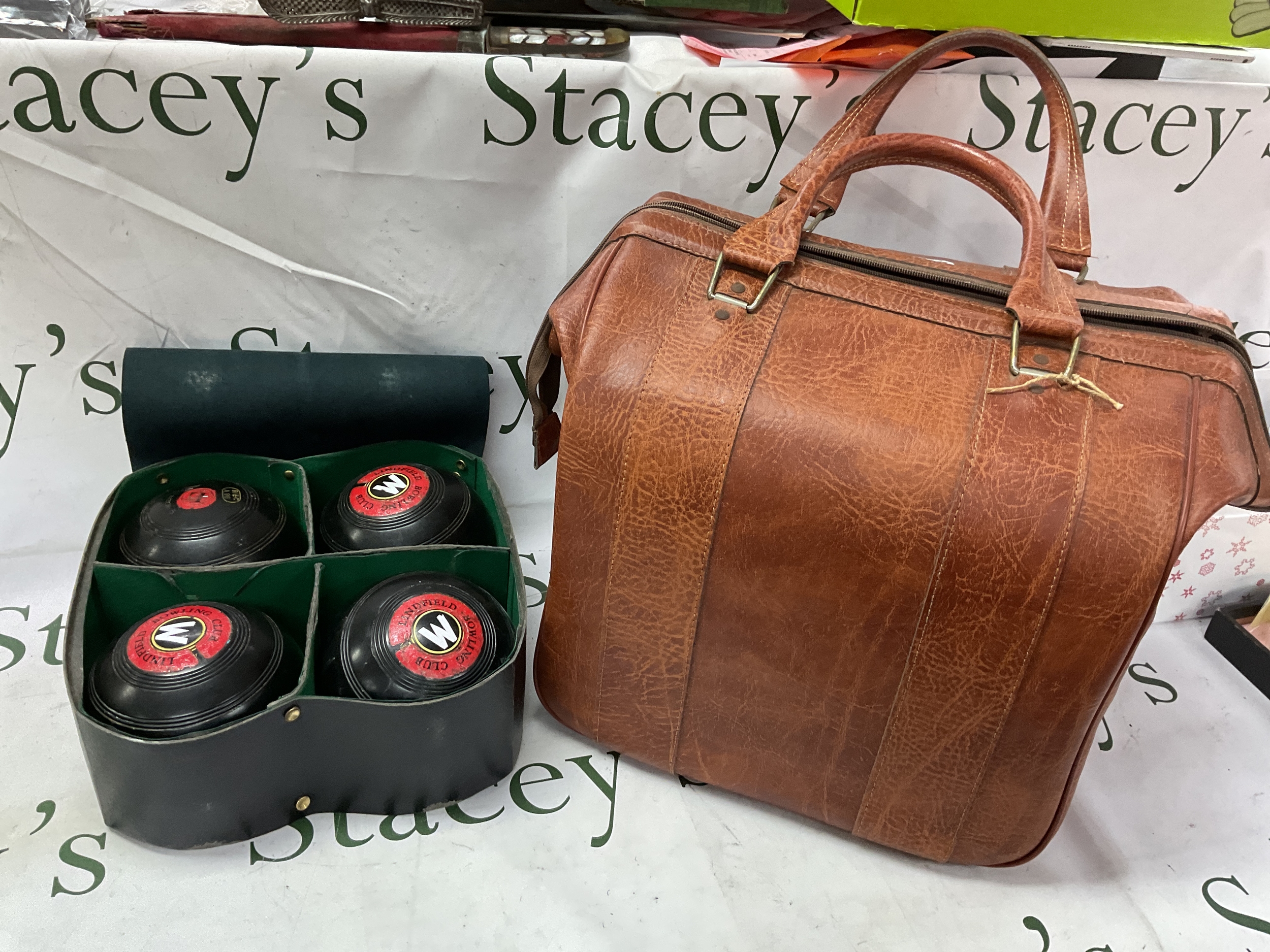 Set of four lawn bowls and large leatherette bag.