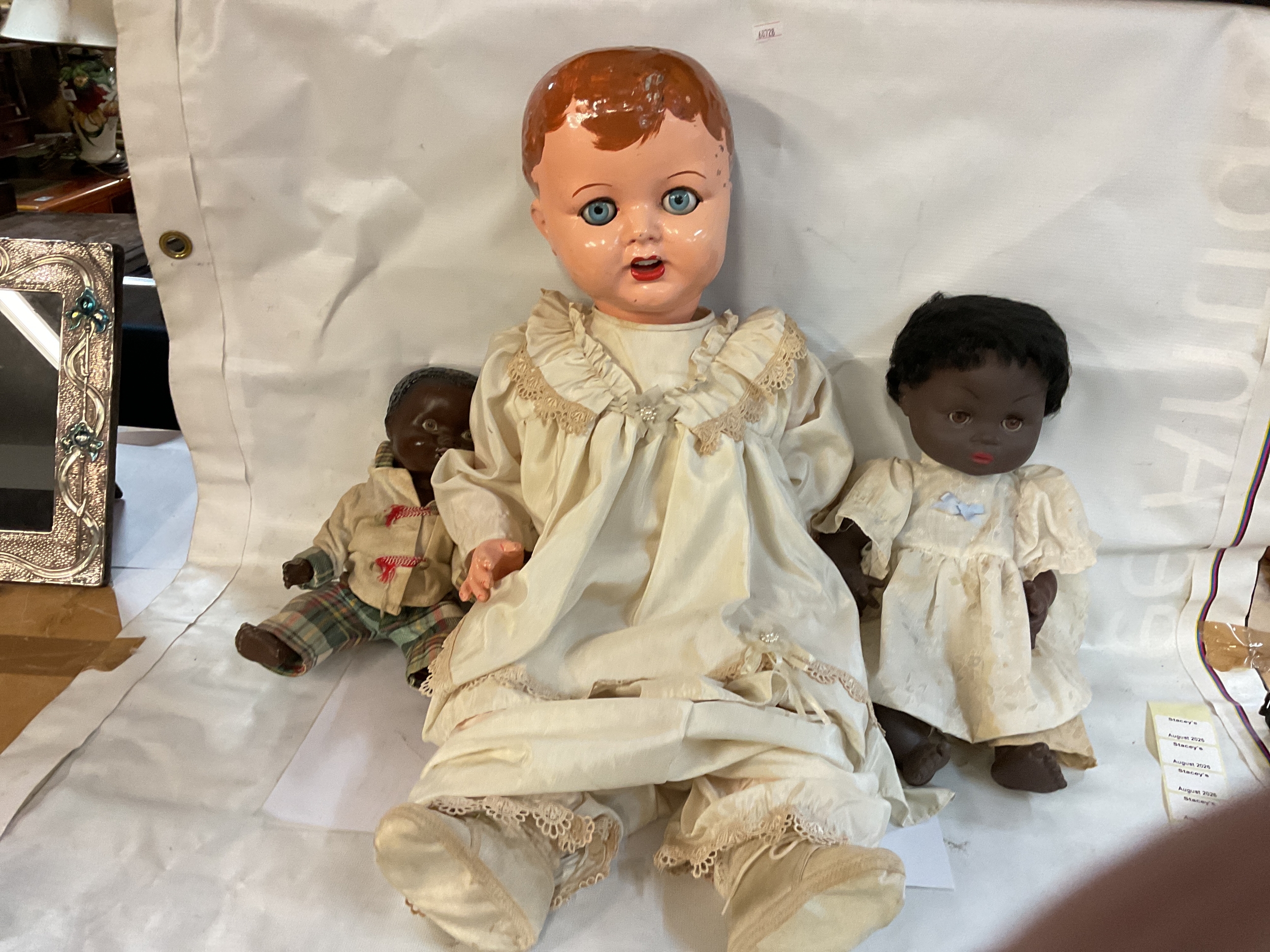 Large vintage doll and two later smaller examples.