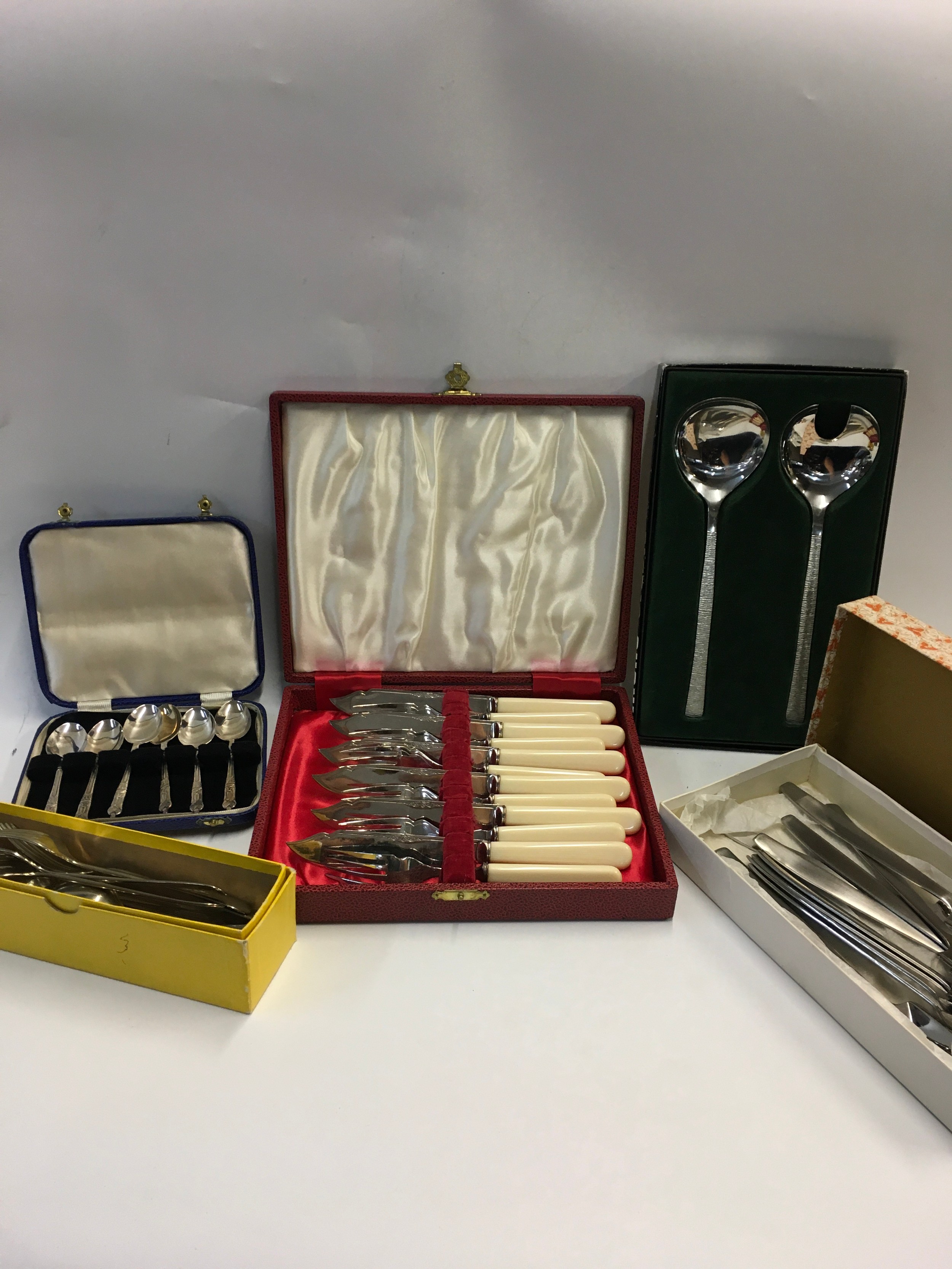 A collection of nickel cutlery and a case of silver knives and forks.