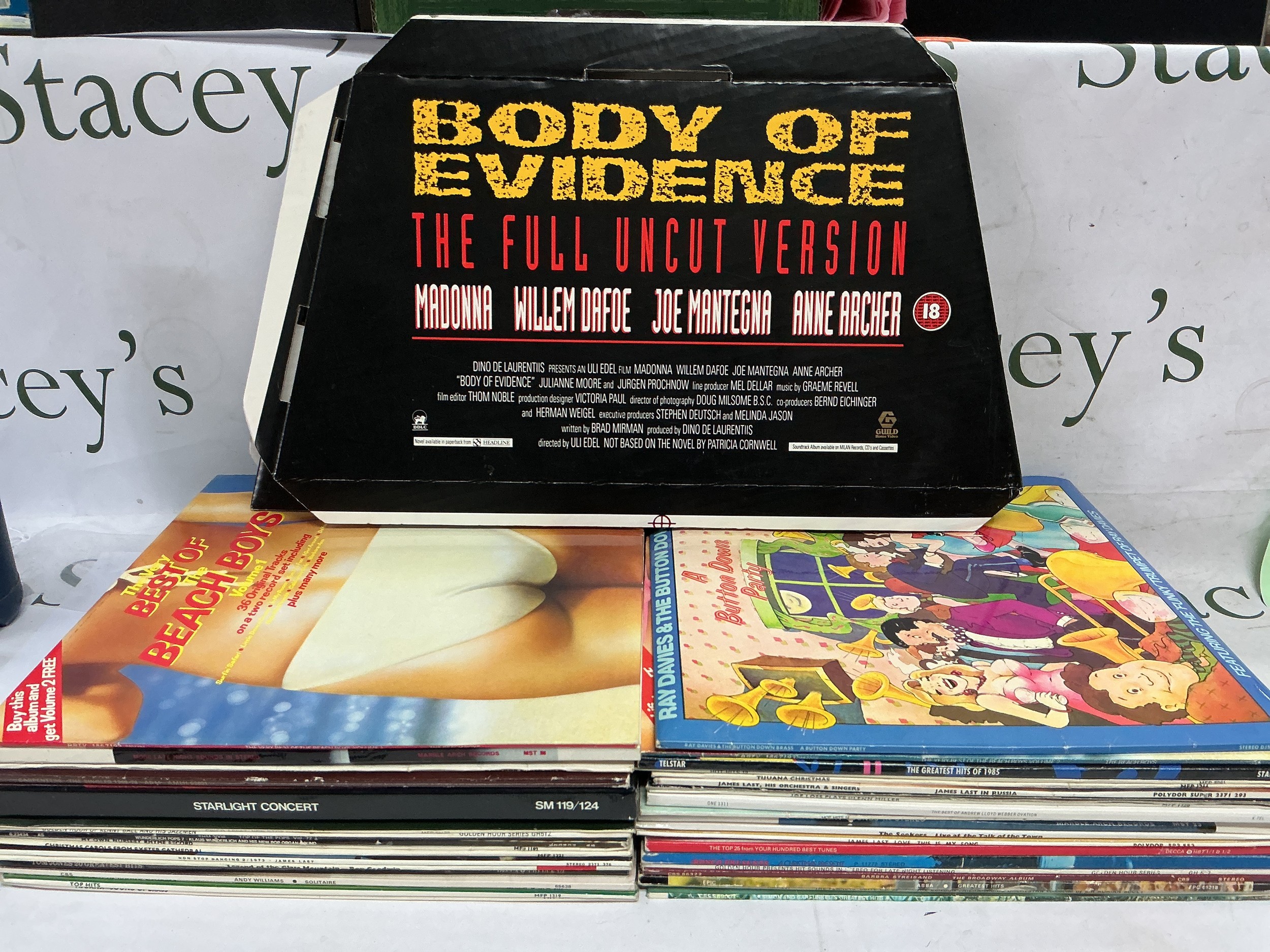 Three bags of LPs by various artists including ABBA, Beach Boys and others plus four Body Of Evidence advertising standees.