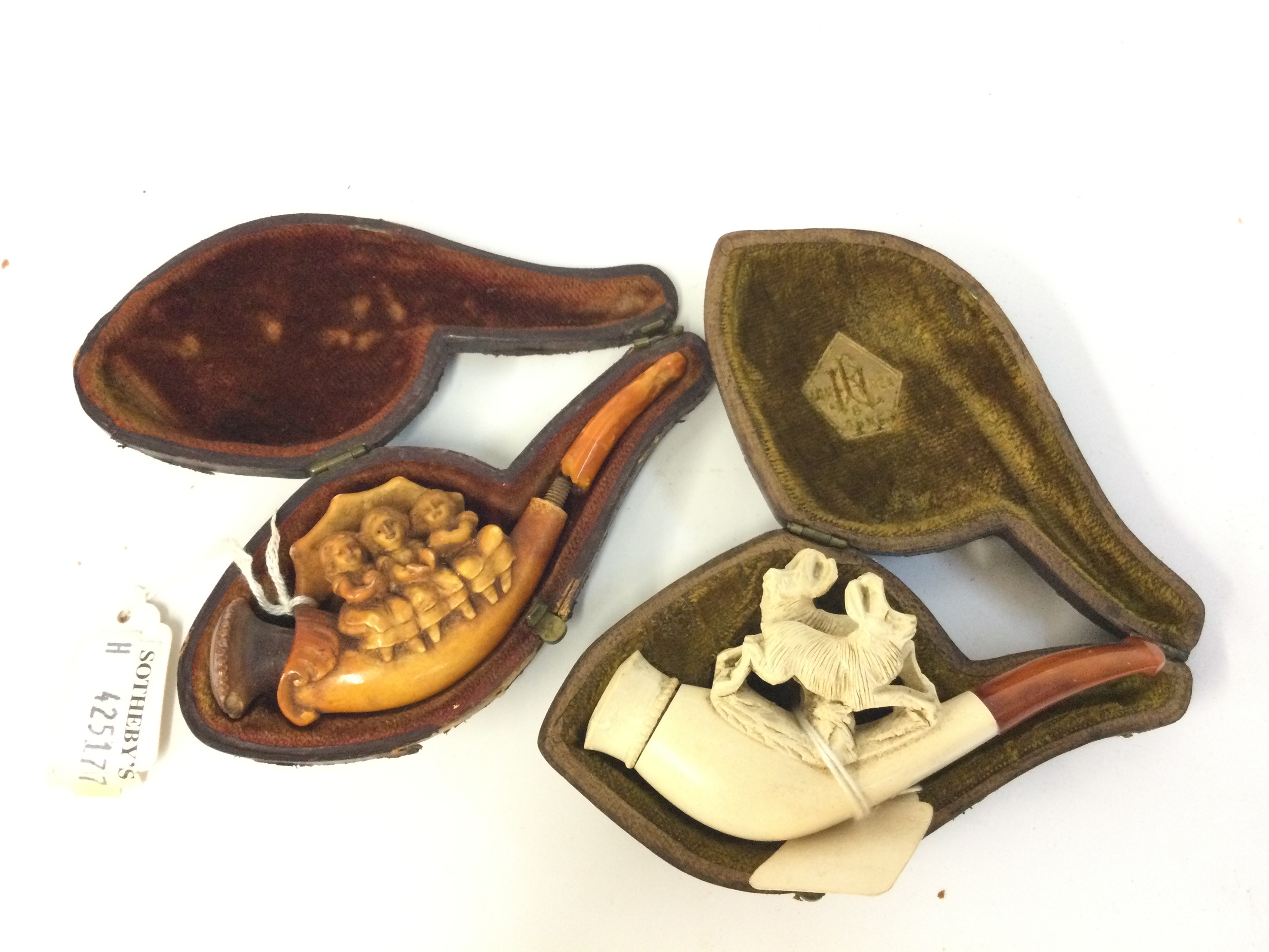 Two cased meerschaum pipes three sitting girls design and goats design. 10 and 9.5cm long 