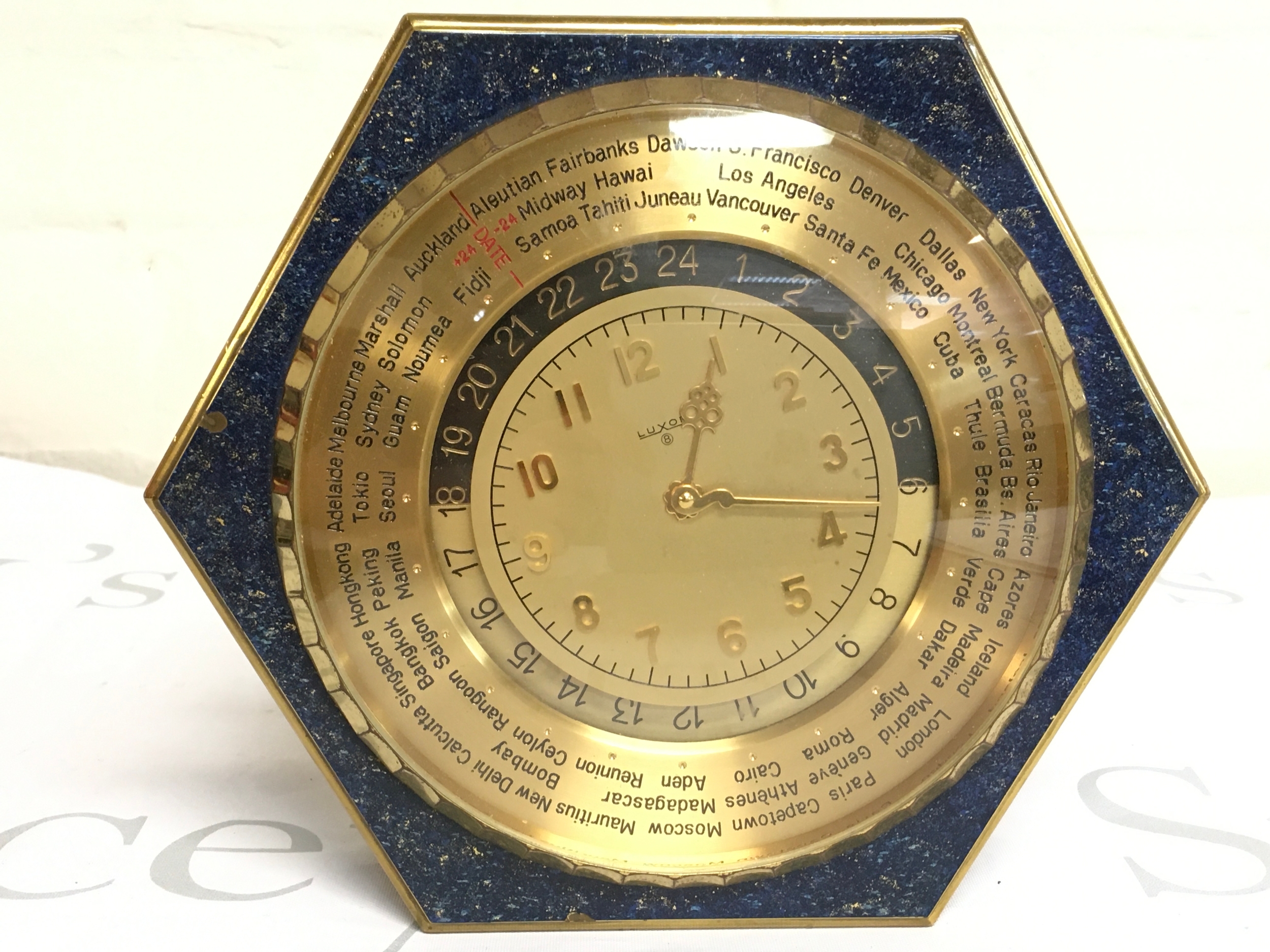 A Luxor Swiss world time desk clock with a distinctive hexagon shape. 20cm wide 18cm tall. No reserve