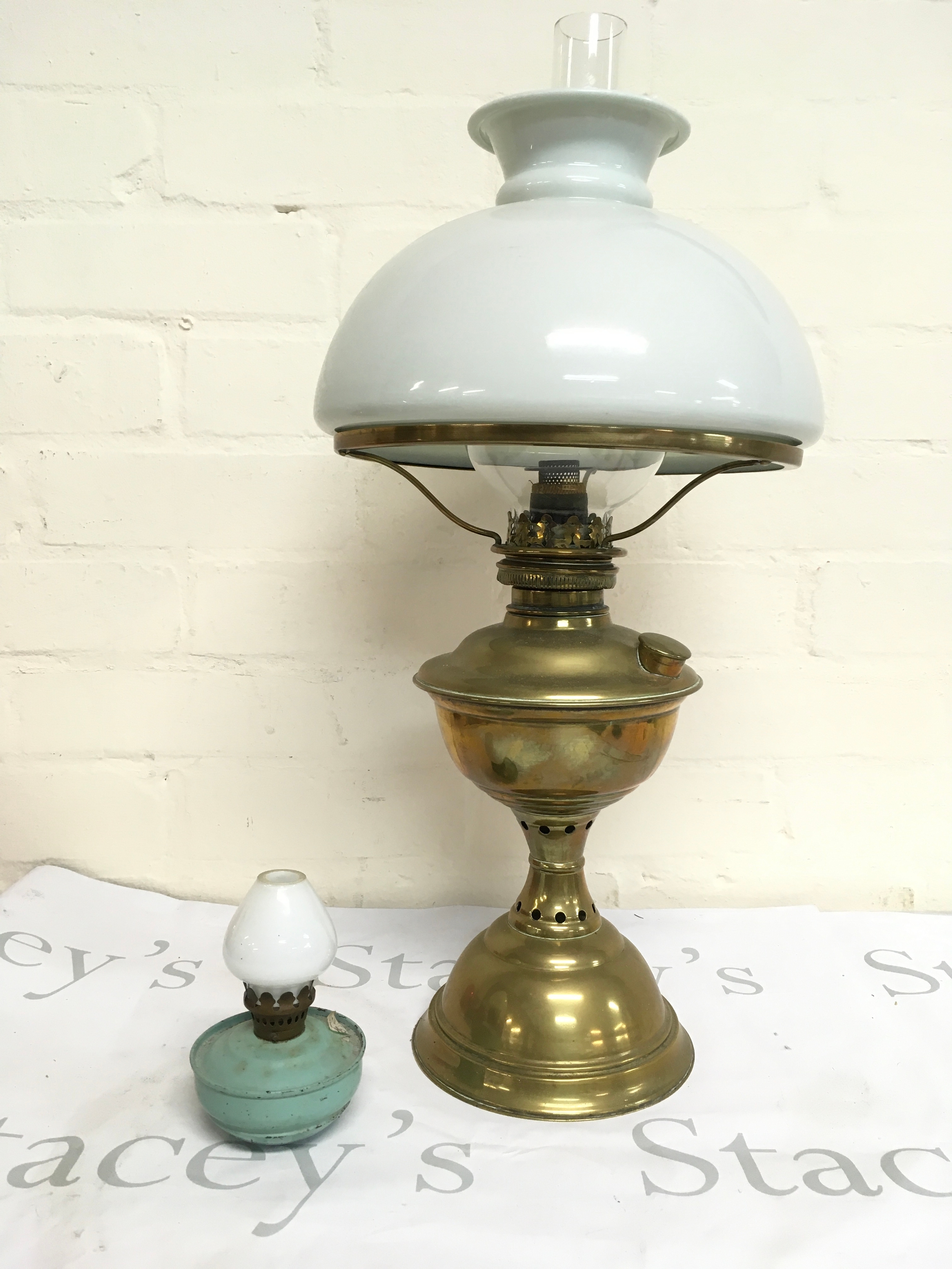 A brass oil lamp with a white glass shade, 54cm tall and a mini oil lamp