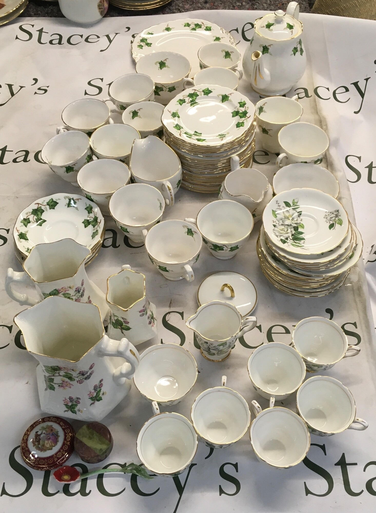 A collection of traditional British tea ware, featuring a classic trailing ivy leaf motif on a crisp white ceramic body NO RESERVE