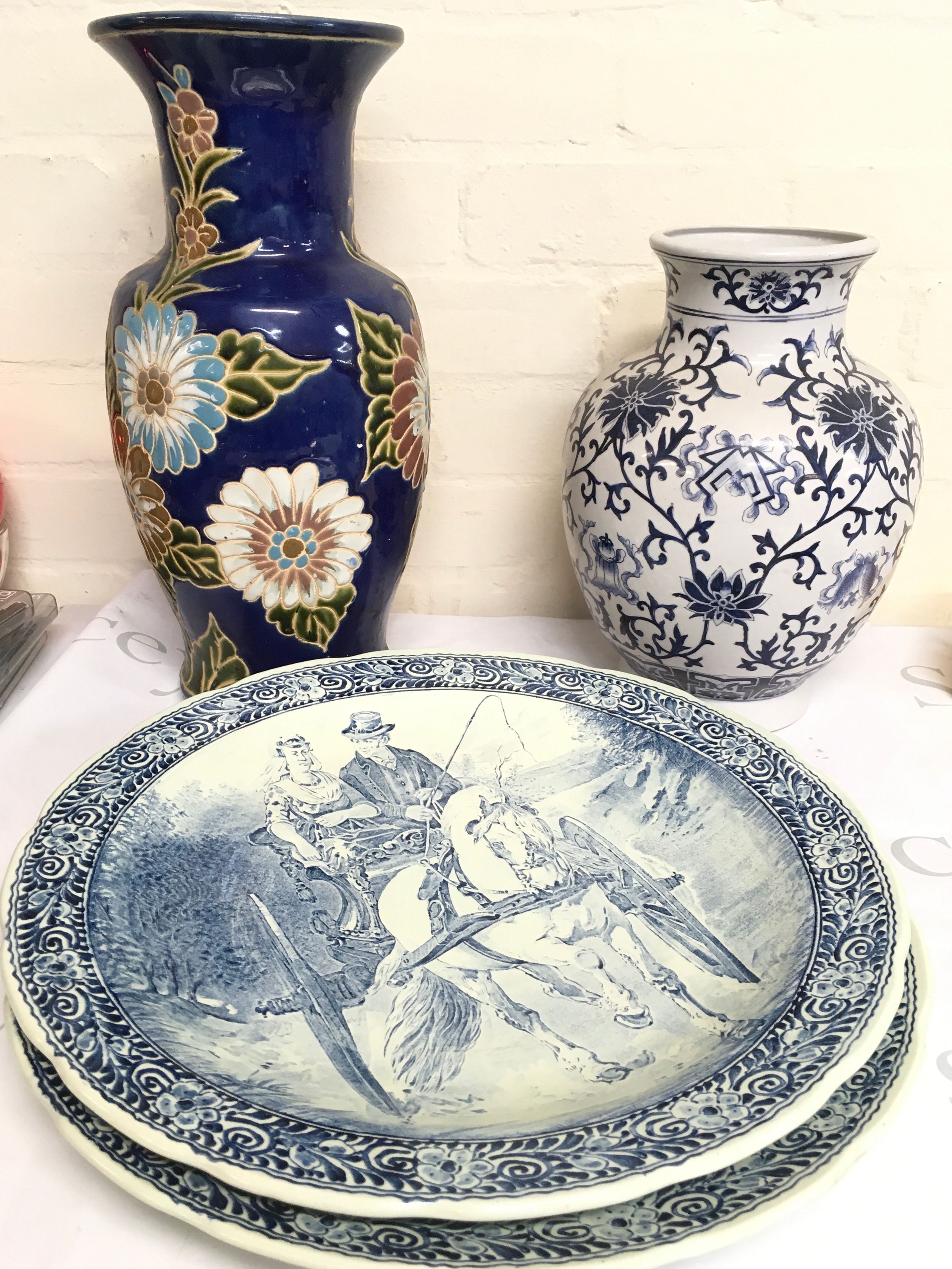 Two Delfts dishes (38cm wide) by Boch Belgium and two ceramic vases one of blue and white design and the other with a cobalt blue background and floral design (41cm tall and 31cm).